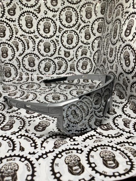 Silver sports sunglasses designed for cycling and outdoor use.