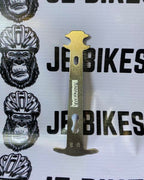 Aluminum chain checker tool for bike drivetrain wear measurement.