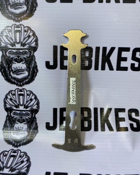 Aluminum chain checker tool for bike drivetrain wear measurement.