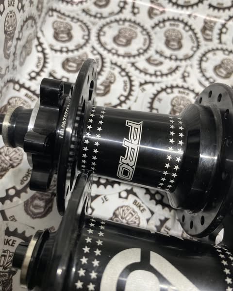 Purple and black TTPRO 9 hubs, 32-hole, 6-pawl, 6-bolt QR system.