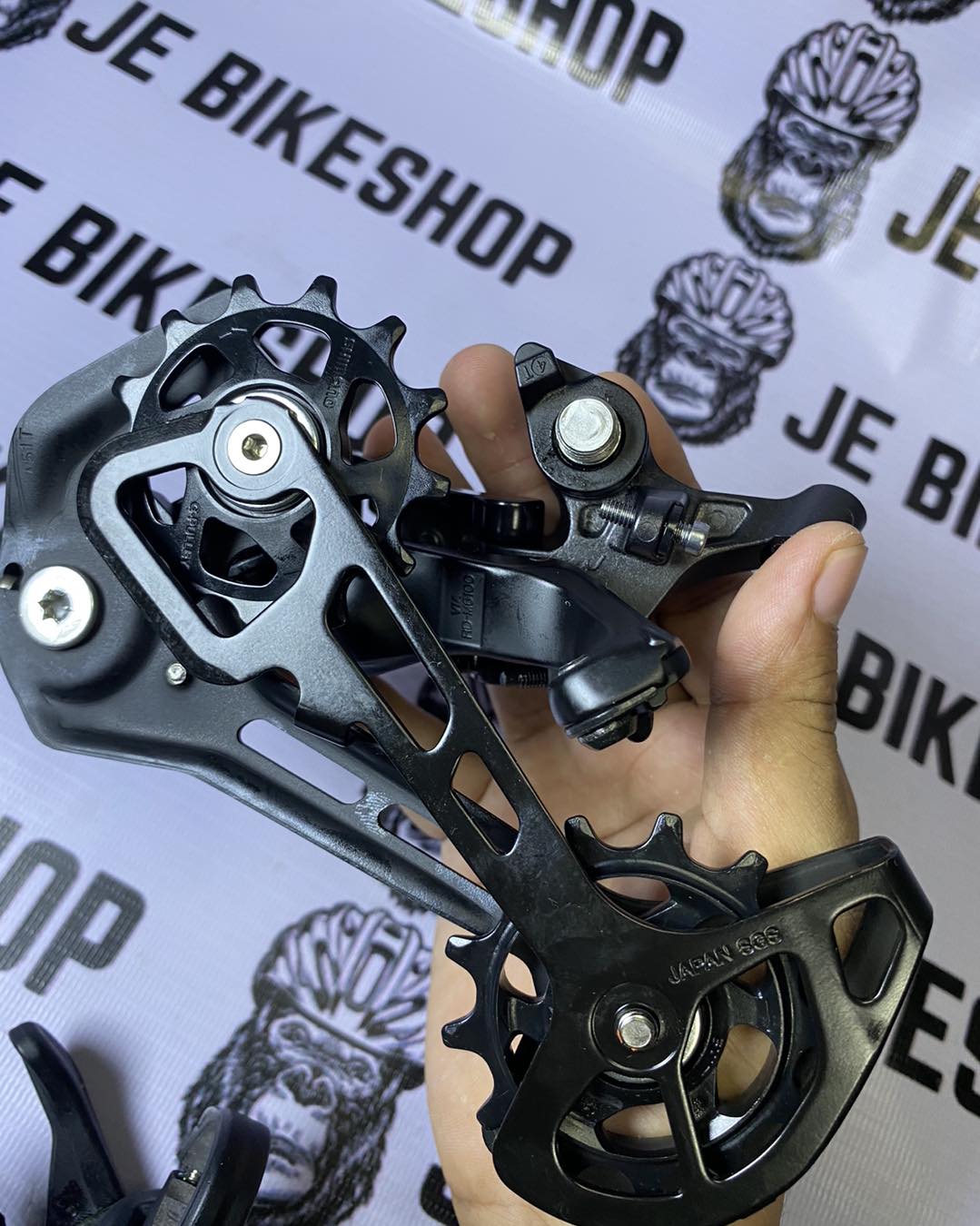 Shimano Deore M6100 51T max clutch rear derailleur with 12-speed cable shifter combo.