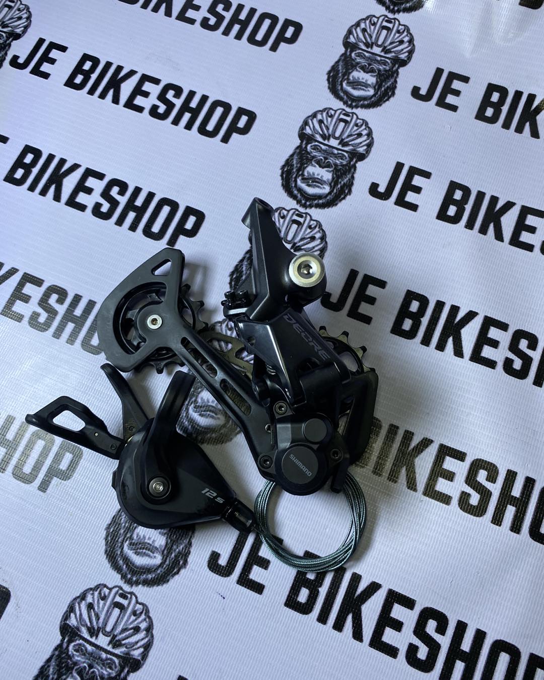 Shimano Deore M6100 12-speed bike component set with clutch RD and cable-equipped shifter.