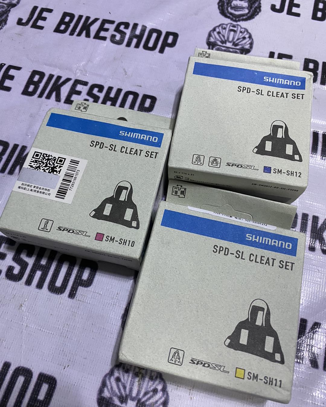 Shimano boxed road bike shifter attachments in red, blue, yellow.